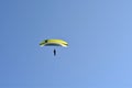 Solo paraglider is flying against the sun on a blue sky on a sunny day in Hungary