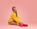 Portrait of young beautiful girl, female ballet dancer training isolated over pink background. Royalty Free Stock Photo