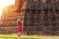 Solo traveler concept. happy Asian woman tourist in red dress taking picture of old pagoda around history temple for cultural