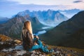 Solo traveler enjoying landscape in Norway Lofoten islands aerial view woman traveling outdoor relaxing on the top of mountain Royalty Free Stock Photo