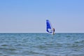 Solo traveling man on the windsurf in the sea with sky background Royalty Free Stock Photo