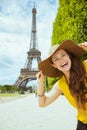 Solo traveller woman against clear view of Eiffel Tower