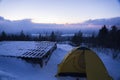 Mountain top winter camping during sunset Royalty Free Stock Photo