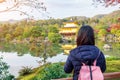 Solo woman tourist trveling at Kinkakuji temple or the golden pavilion in Autumn season, Asian traveler visit in Kyoto, Japan. Royalty Free Stock Photo