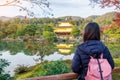 Solo woman tourist trveling at Kinkakuji temple or the golden pavilion in Autumn season, Asian traveler visit in Kyoto, Japan. Royalty Free Stock Photo