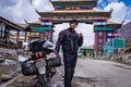 Solo young bike ridder man with his loaded bike at mountain pass at day from flat angle Royalty Free Stock Photo