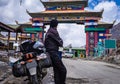 Solo young bike ridder man with his loaded bike at mountain pass at day from flat angle Royalty Free Stock Photo