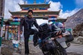 Solo young bike ridder man with his loaded bike at mountain pass at day from flat angle Royalty Free Stock Photo