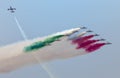 Plane jet soloist at the italian tricolor arrows air show performs a cross acrobatic figure