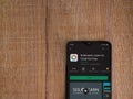 SoloLearn - Learning coding app play store page on the display of a black mobile smartphone on wooden background