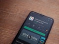 SoloLearn - Learning coding app play store page on the display of a black mobile smartphone on wooden background