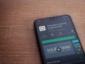 SoloLearn - Learning coding app play store page on the display of a black mobile smartphone on wooden background