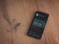 SoloLearn - Learning coding app play store page on the display of a black mobile smartphone on wooden background