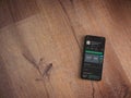 SoloLearn - Learning coding app play store page on the display of a black mobile smartphone on wooden background