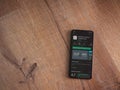 SoloLearn - Learning coding app play store page on the display of a black mobile smartphone on wooden background