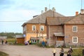 Solovky, RUSSIA - Aug 25 2015, North village with wooden barracks with post office and people walking on dirt road, on Aug 25