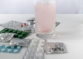 Soluble tablet in a glass of water. Tablets in packing on a light background