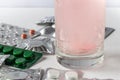 Soluble tablet in a glass of water. Tablets in packing on a light background