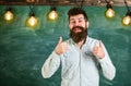 Solution concept. Guy has idea, shows thumb up gesture. Man with beard and mustache on happy smiling face stand in front Royalty Free Stock Photo