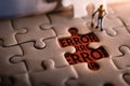 Solution Solving Problem Concept. a Miniature Worker Man Found Error Message on a Piece of Jigsaw Royalty Free Stock Photo