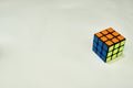Solved rubik`s cube in blue yellow and orange on white background with copy space