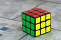 Solved Rubik`s cube on ceramic background.