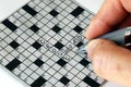 Solving the cross word puzzle Royalty Free Stock Photo