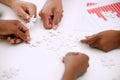 Solving this issue one piece at a time. Closeup shot of a group of unrecognizable businesspeople holding puzzle pieces Royalty Free Stock Photo