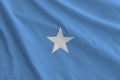 Somalia flag depicted on folded wavy fabric of old cloth Royalty Free Stock Photo