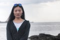 A somber chinese woman on the maine coast