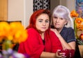 Somber Mother and Daughter in kitchen