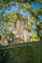 A somber Stature guards the Entrance to the Bonaventure Cemetery historic landmark in Savannah Georgia