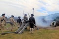 Somber view of young men firing canons during war reenactments, Fort Ticonderoga, New York, 2016
