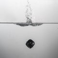 some black game dice drop in water with a splash Royalty Free Stock Photo