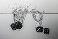 some black game dice drop in water with a splash Royalty Free Stock Photo