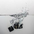 some black game dice drop in water with a splash Royalty Free Stock Photo