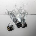 some black game dice drop in water with a splash Royalty Free Stock Photo