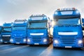 Blue trucks in line composing