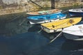 Some boat bright colors on background blue water lake of pier, fishing and boating on summer landscape, holiday travel and sun Royalty Free Stock Photo