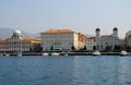 Some boats dock with buildings and church in the center of Trieste in Friuli Venezia Giulia (Italy) Royalty Free Stock Photo