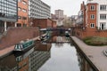 some boats docked near some buildings in the water of a canal