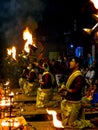 Some Brahman priest wearing red and yellow dress doing traditional ganga aarti at dasaswamedh ghat, Varanasi, Uttar Pradesh, India