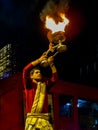 Some Brahman priest wearing red and yellow dress doing traditional ganga aarti at dasaswamedh ghat, Varanasi, Uttar Pradesh, India