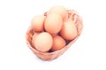 Some brown eggs in a wicker basket isolated on white background Royalty Free Stock Photo