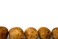 Some brown potatoes on white background close up