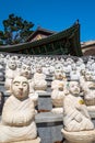 Some of the 500 BuddhaÃ¢â¬â¢s Disciples statues by a temple hall in Bomunsa Temple, Seongmodo, Ganghwa, Incheon, Korea