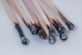 Some burned matches lie side by side on a white base Royalty Free Stock Photo