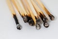 Some burned matches lie side by side on a white base Royalty Free Stock Photo