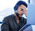 Some callers really just give you a headache. a young call centre agent looking stressed out while working in an office. Royalty Free Stock Photo