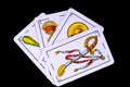 Some cards from the spanish deck for playing cards games and gambling on a black background Royalty Free Stock Photo